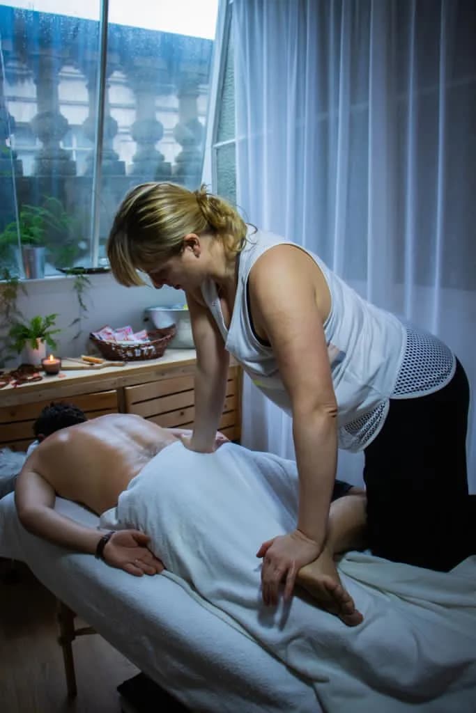 Masseur performing a deep back massage